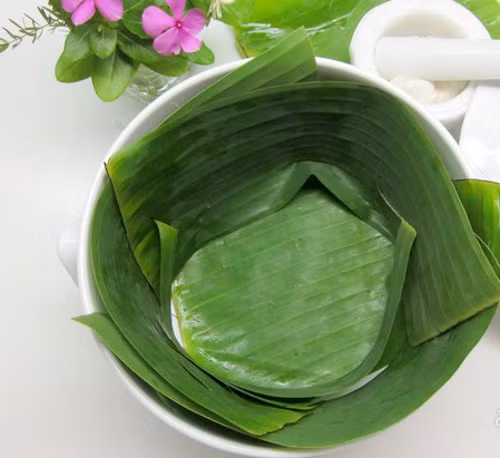 Men rượu nhặt sạch vỏ trấu ủ bên ngoài, cho vào cối giã nhuyễn, dây qua lưới lọc để tránh bị lẫn vỏ trấu khi ăn. Lá chuối (hoặc lá sen) rửa sạch, lau khô rồi lót vào rổ sạch để sau này khi ủ rượu nước không bị ứ, nước ủ rượu dễ chảy xuống. Bớt lại ít lá để phủ lên bề mặt khi ủ.Ảnh: megafun