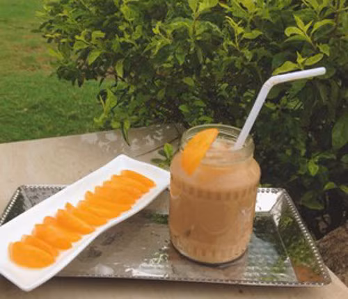 Cho trà sữa ra ly, thêm vào một ít đá. Từ từ đổ nước đào vào ly trà cho ngấm đều. Cho thêm vài lát đào vào ly để tăng hương vị và sự hấp dẫn cho ly sữa. Ảnh: trithuctre