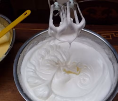 Cho kem tươi ra bát tô và dùng máy đánh bông kem lên. Đổ phần sữa mận đã xay vào trộn đều. Ảnh: taymay