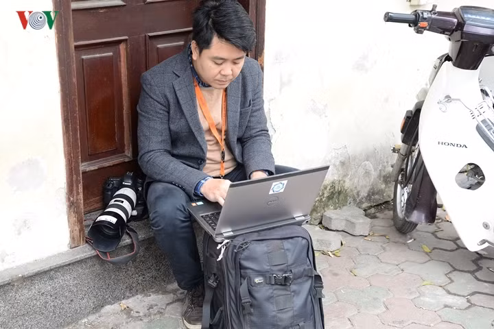Phóng viên ảnh của Thông tấn xã Việt Nam tranh thủ gửi ảnh từ hiện trường về cơ quan.