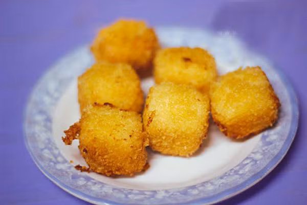 Sữa chiên có nguồn góc từ Tây Ban Nha, là món ăn mới được du nhập vào Hà Nội, nhưng chỉ trong thời gian ngắn, nó đã làm điên đảo cộng đồng trẻ. Món ăn vặt này được chế biến từ những nguyên liệu chính là bột bắp, sữa tươi và đường. Tuy cách chế biến đơn giản nhưng lại lôi cuốn bất cứ ai. Cắn một miếng sữa chiên ngập răng là điều tuyệt vời nhất trong đêm đông lạnh. Ảnh: Lamsao.com.