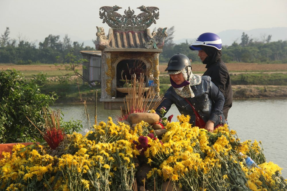 Dù cơ quan chứng năng đã chứng minh con rắn chỉ là rắn nước và mang nó thả về tự nhiên nhưng dòng người vẫn tìm về mộ "Bà ăn mày" để quỳ lạy thắp nhang để cầu tài lộc. (Ảnh: Hải Long).