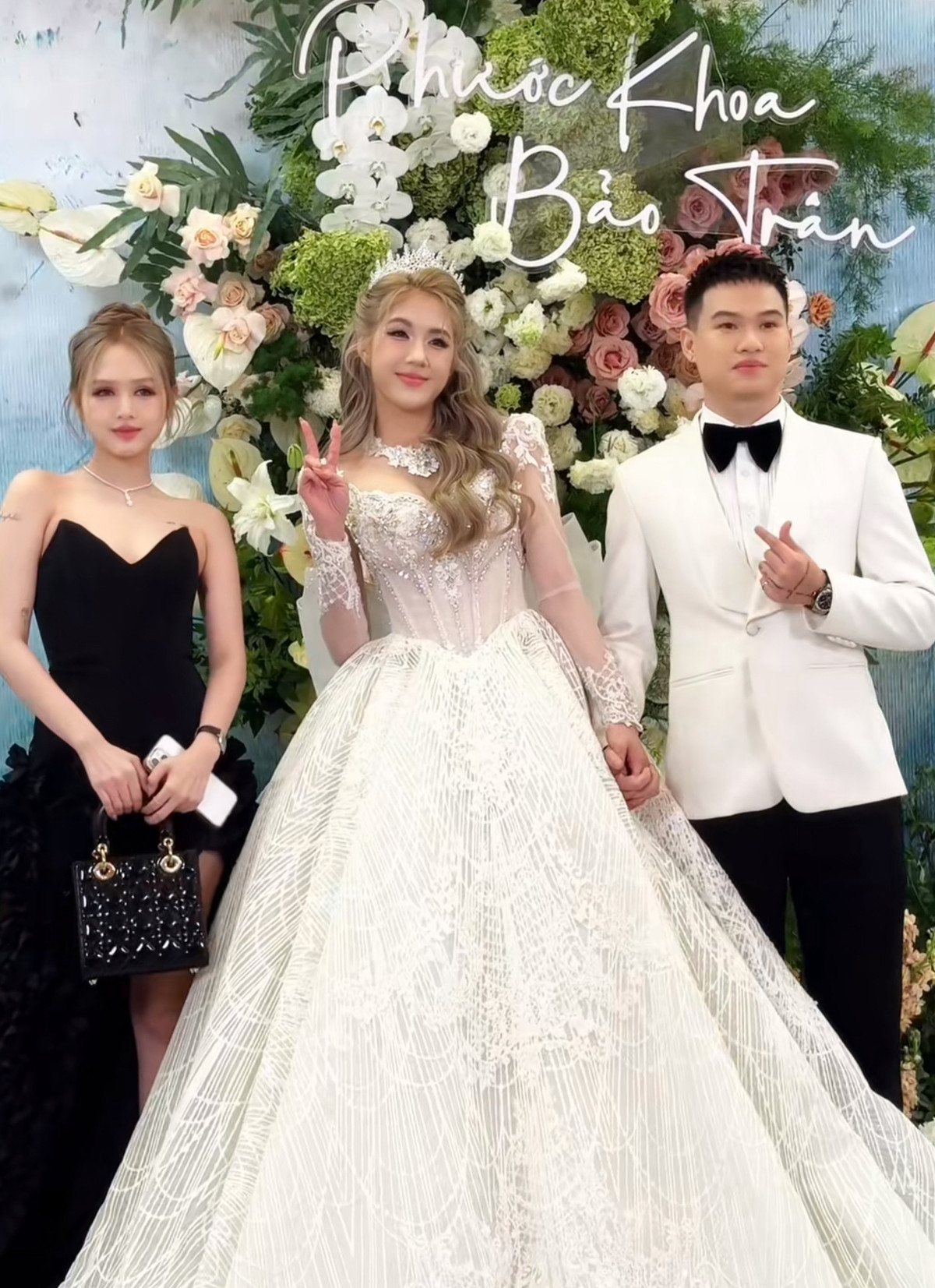 Xoài Non với ngoại hình xinh đẹp, rạng rỡ chụp hình check-in cùng chú rể và cô dâu. Dù thiệp mời được ghi là em Xoài và icon trái tim nhưng cô nàng chỉ xuất hiện lẻ bóng, không có Gil Lê sánh vai.