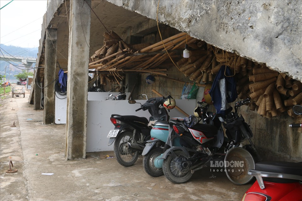 Gầm cầu thang lên xuống được tận dụng làm bãi đỗ xe và một số vật dụng đặc trưng của dân chài. 