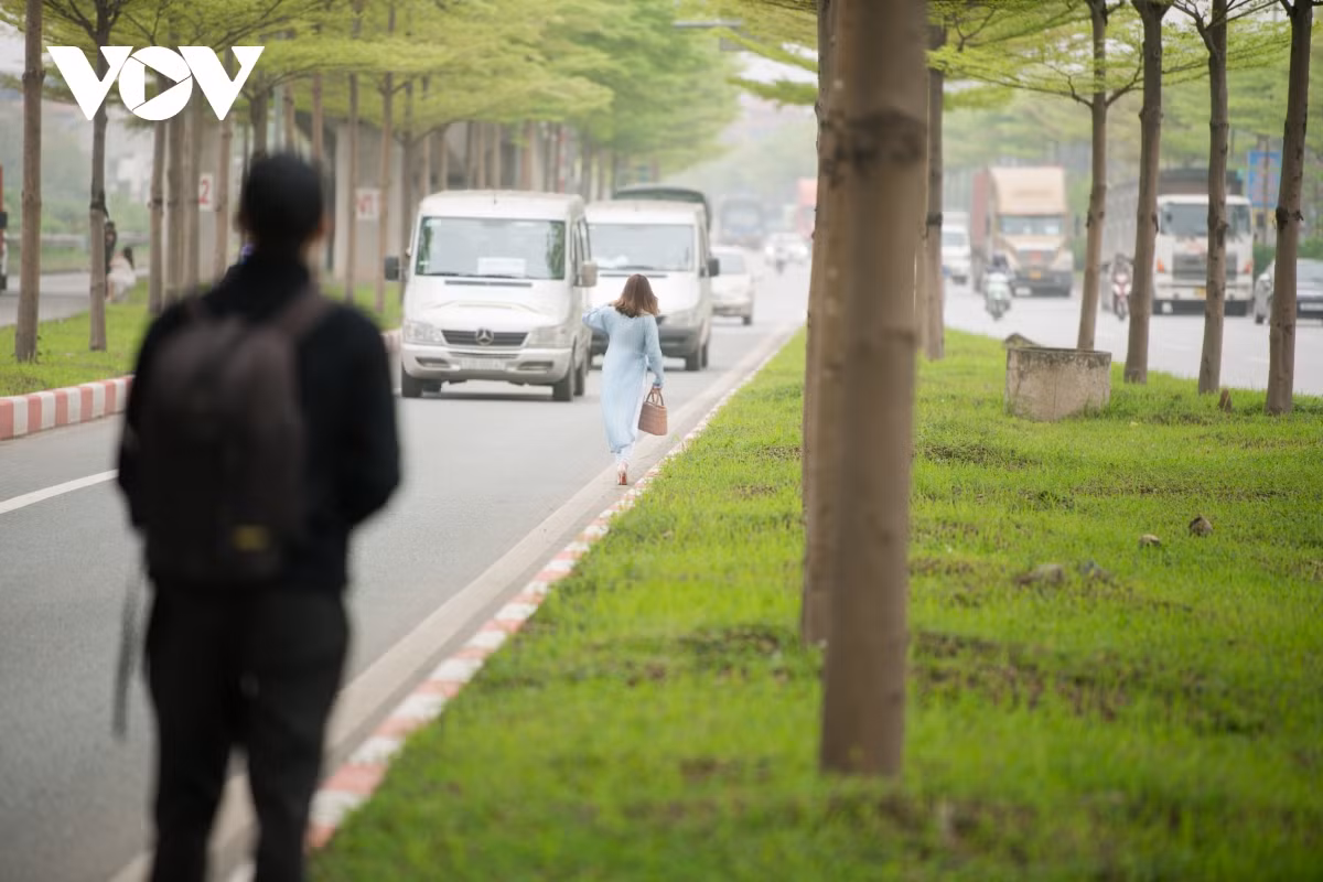 Người dân thản nhiên đi bộ dưới lòng đường.