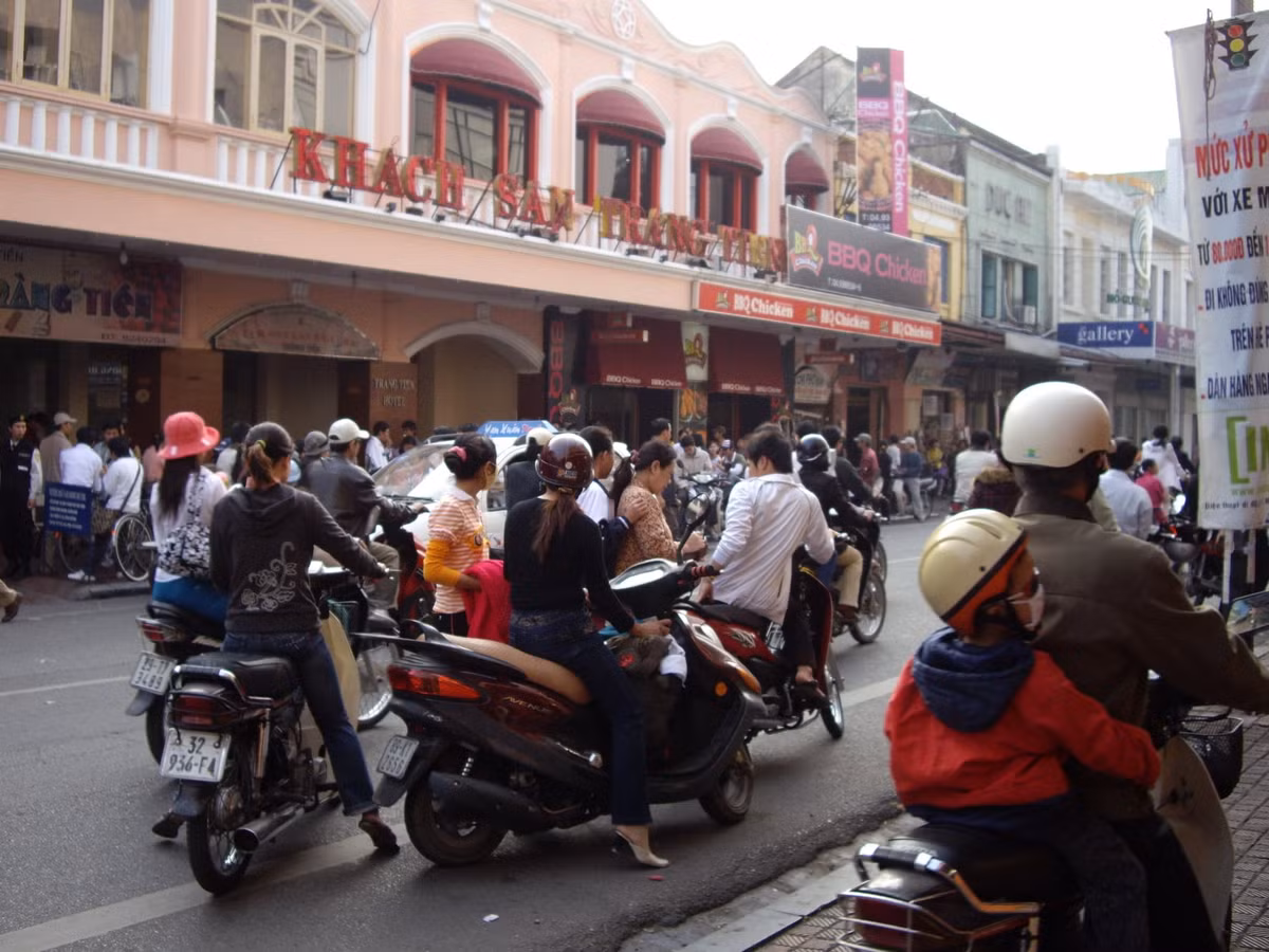 Phố Tràng Tiền, đoạn phía trước cửa hàng kem Tràng Tiền, năm 2008. Cạnh hàng kem huyền thoại có một nhà hàng BBQ Chicken của Hàn Quốc mới mở. Cả hai đều đông khách. Ảnh: Yuichi Kobayashi.