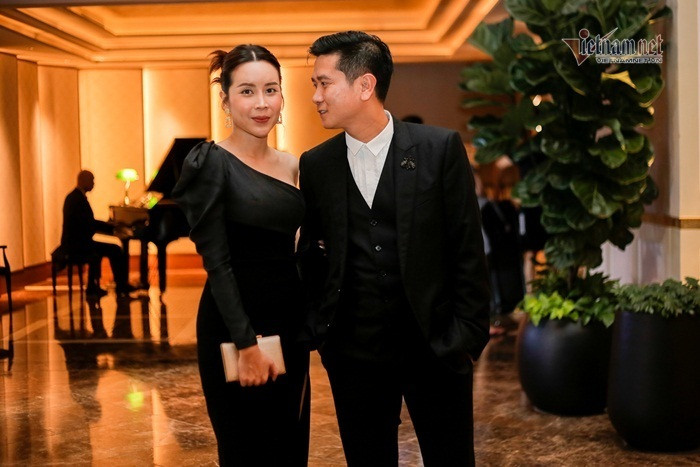 Vợ chồng Lưu Hương Giang - Hồ Hoài Anh tay trong tay, tình tứ đến chúc mừng đàn em. Lưu Hương Giang gợi cảm trong bộ váy đen ôm sát người, khoe một bên vai trần.