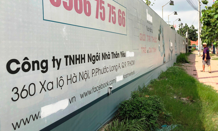 Bảng thông tin về dự án đặt bên ngoài công trình, ngay tuyến song hành XLHN tấp nập.