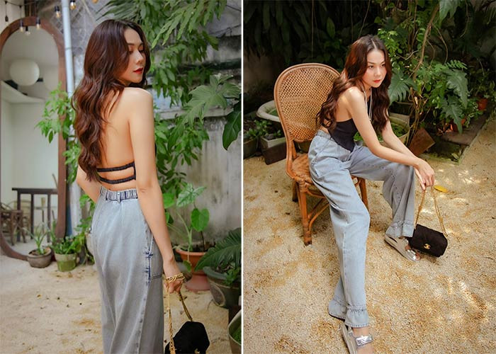 Quần jeans ống rộng kết hợp với áo yếm đen khoe lưng trần, Thanh Hằng gợi cảm khó cưỡng.