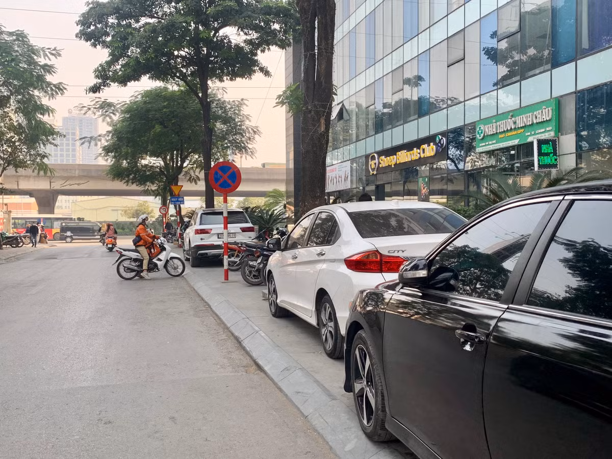 Điều đáng nói, mặc cho có biển cấm dừng cấm đỗ, những chiếc xe ô tô và cả xe máy vẫn ngang nhiên đỗ trên vỉa hè mà không bị lực lượng chức năng xử lý.