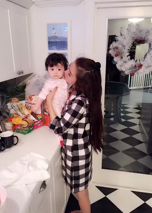 Một lần đón Giáng sinh tại nhà họ hàng ở nước ngoài bên bé Mộc Trà lúc còn nhỏ, Elly Trần cũng từng gây chú ý khi đăng tải bức ảnh phản chiếu một người đàn ông đang chụp hình cho hai mẹ con. Ảnh: Khám phá