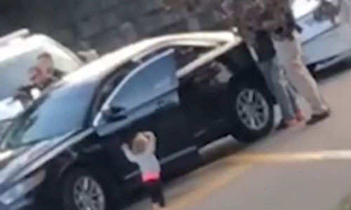 Be gai 2 tuoi bo ra khoi xe, di chan dat va gio tay dau hang canh sat