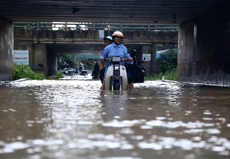 Đường chui dẫn từ Đại lộ Thăng Long sang phía Thiên Đường Bảo Sơn nước ngập rất sâu, các xe máy không thể đi được và chết máy liên tục.