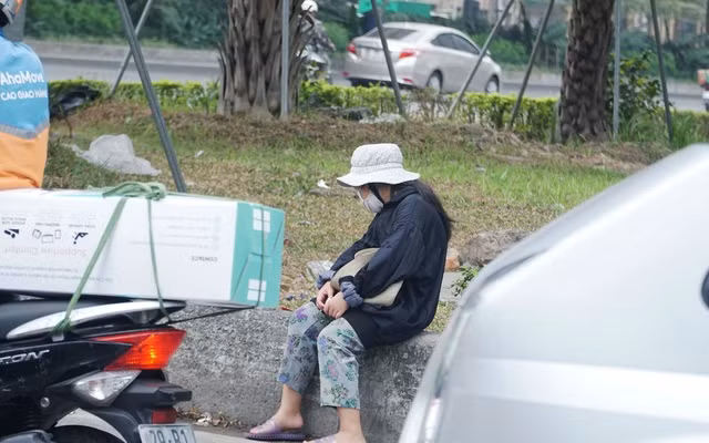 Tại Ngã Tư Dương Đình Nghệ - Phạm Hùng, giữa lúc dòng phương tiện đang im ắng dừng chờ đèn đỏ thì những bóng người thấp thoáng di chuyển, phụ nữ có, trẻ nhỏ có, tất cả đều đang miệt mài mời chào để bán hàng. 