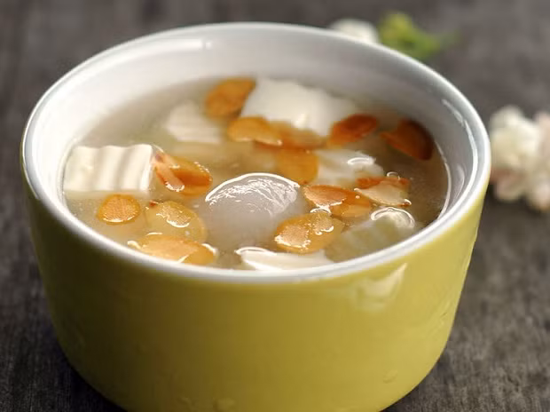 Nguyên liệu để làm chè khúc bạch bao gồm: 250ml sữa tươi, 250ml kem tươi, 13-15g gelatin dạng bột, 3 thìa canh đường, hạnh nhân thái lát, cùi vải hoặc nhãn. 