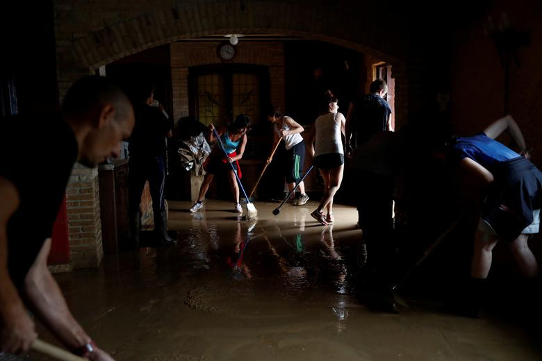 Mọi người dọn dẹp bên trong một nhà hàng ở Tafalla sau trận mưa lớn.