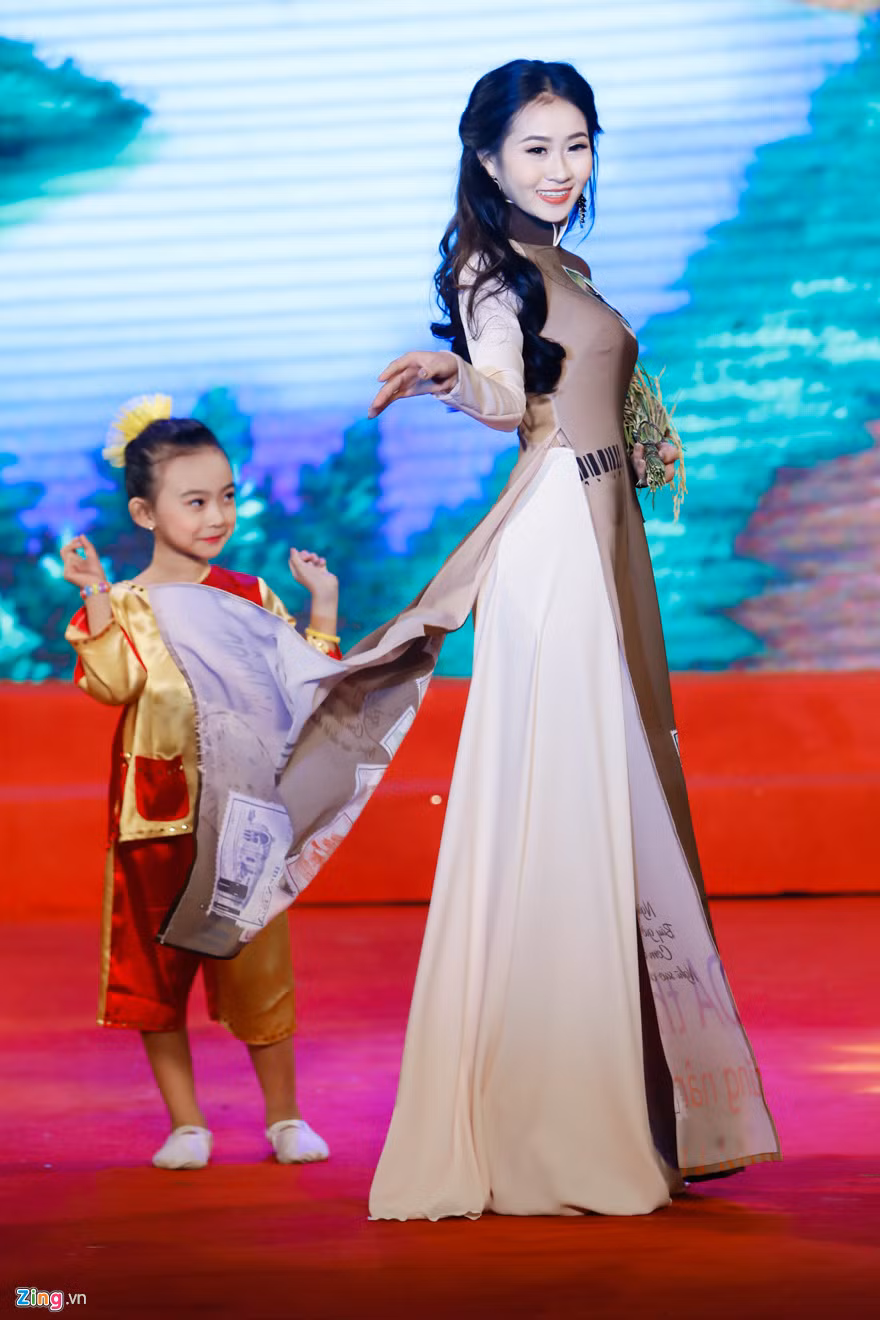 Điểm nhấn độc đáo cho phần trang phục áo dài là hình ảnh những con tem xưa được in trên trang phục.