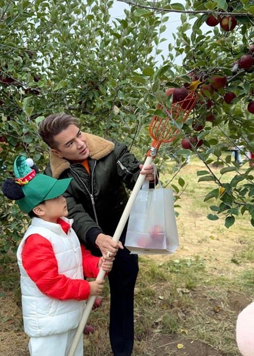 Nam ca sĩ đưa con trai đi thu hoạch táo. Ảnh: FB Đàm Vĩnh Hưng.