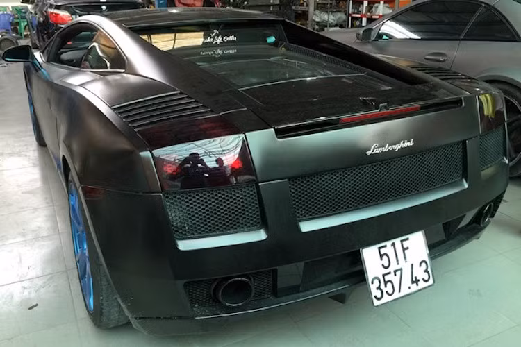 Chiếc "siêu bò" Lamborghini Gallardo SE duy nhất tại Việt Nam vốn có màu vàng, nhưng đã được chủ xe dán lại màu đen mờ và sơn mâm màu xanh tạo điểm nhấn.