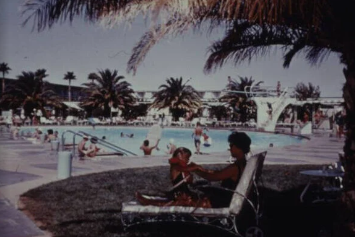 Một người phụ nữ và đứa con đang thư giãn bên hồ bơi của một khách sạn ở Las Vegas vào khoảng năm 1960.