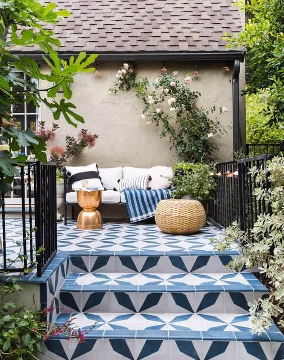 Một góc sân "xinh như mộng" nhờ những bông hoa hồng nhỏ nhắn lại càng nổi bật với lớp gạch đá hoa màu trắng xanh.