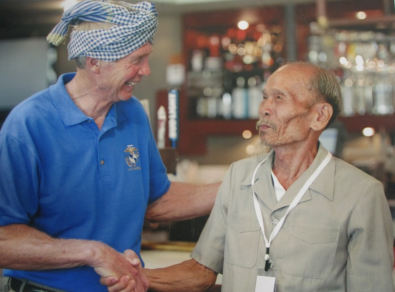 Ông Bảy bắt tay với một phi công Mỹ sau khi ông tặng chiếc khăn rằn (Ảnh: Nhân vật cung cấp).