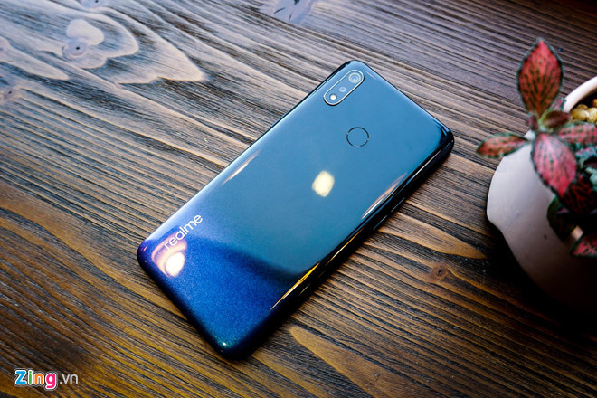 Mặt sau máy dùng chất liệu nhựa giả kính, bo cong về 2 cạnh mang đến cảm giác cầm nắm thoải mái. Đồng thời, mặt lưng của Realme 3 được chuyển từ màu đen sang màu xanh, khá bắt mắt khi nhìn.