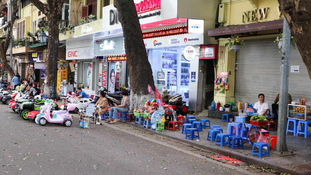 Để phục vụ cho nhu cầu, trên vỉa hè của con phố đi bộ Hồ Gươm, chẳng biết từ bao giờ đã mọc lên rất nhiều những hàng quán trái phép, lấn chiếm lòng đường dành cho dòng người thả bộ ở giữa trung tâm Thủ đô.