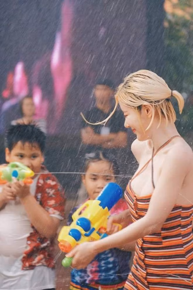 DJ Soda sở hữu làn da trắng sứ, mái tóc ngắn vàng cá tính và đặc biệt là body cực kì nóng bỏng. Dù đang phải chịu từng đợt "bom" nước khiến cả người ướt sũng nhưng nhìn cô nàng vẫn vô cùng tỏa sáng.