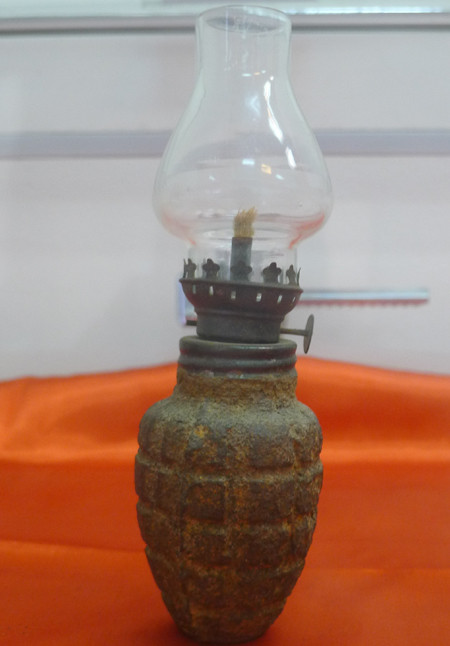 Chiếc đèn dầu với phần dưới làm từ vỏ đạn hạt na cũng được dân mạng chia sẻ trên mạng xã hội trong kho đồ album kỉ vật của ông bà.