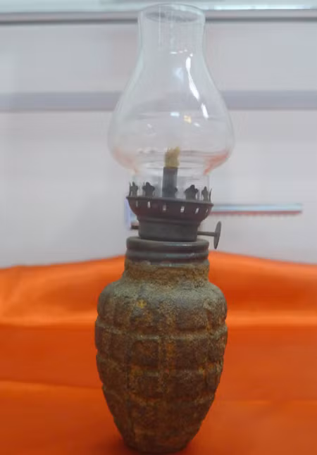 Chiếc đèn dầu với phần dưới làm từ vỏ đạn hạt na cũng được dân mạng chia sẻ trên mạng xã hội trong kho đồ album kỉ vật của ông bà.