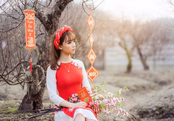 Chẳng cần cầu kì, một bộ áo dài đỏ, thêm vài phụ kiện như câu chúc, bó hoa là các cô gái đã có ảnh đón Tết cực xinh rồi.