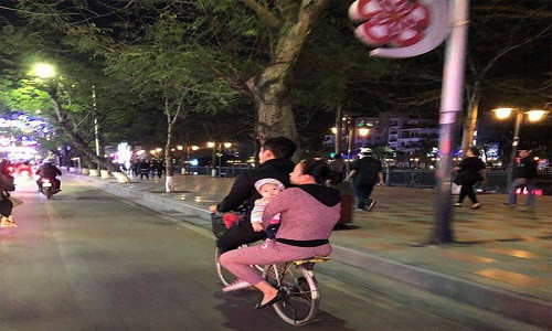 Hình ảnh gia đình nhỏ trên chiếc xe đạp mini cũ giữa dòng người xe hơi, xe sang nườm nượp làm ấm lòng nhiều người.