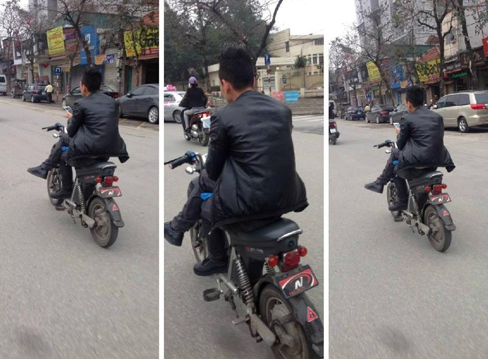 Một anh chàng đi xe điện vắt chân 1 bên kiểu bất chấp tất cả.