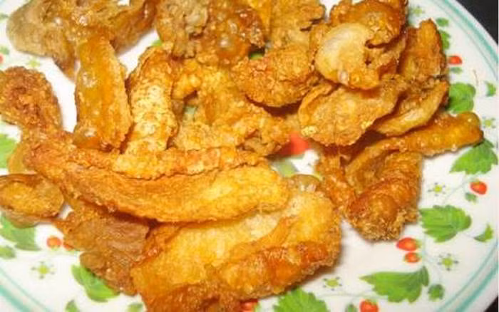 5. Da gà chiên mắm ớt. nguyên liệu gồm da gà, nước mắm, hành tỏi, ớt, ngò, hành tím. Da gà mua về rửa sạch bằng nước muối loãng và để ráo nước sau đó cắt thành miếng vừa ăn và ướp muối. Sau đó tiến hành pha nước sốt: Gồm đường, bột nêm, ớt thái lát và 2 muỗng canh nước mắm khuấy đều. Ảnh: Foody.