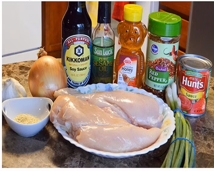 Gà xé hầm mật ong. Nguyên liệu gồm thịt gà, mật ong. Xì dầu, tỏi băm nhỏ, hành tây, bột năng, dầu oliu. Đầu tiên, mẹ xếp ức gà vào nồi sao cho phần ức gà không bị chồng lên nhau. Trộn mật ong, xì dầu, tương đen, dầu olive, tỏi, hành tây và ớt xay với nhau ra một chiếc bát, rồi rưới đều lên thịt gà hầm trong khoảng 4-5 giờ đồng hồ cho đến khi gà chín. Ảnh: Phunuvietkieu.