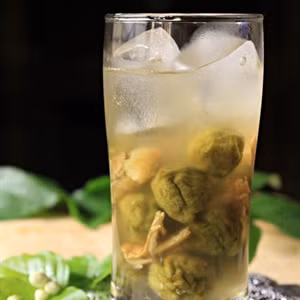 Phần đường còn lại trong nồi các bạn cho gừng đã chuẩn bị trước vào rồi đun lên. Đun sôi một chút cho đường tan hết rồi để nguội hoàn toàn. Dùng muỗng múc phần siro đường này vào hũ sấu. Để khoảng 2 ngày sau là dùng được rồi. Ảnh: Cooky.vn.