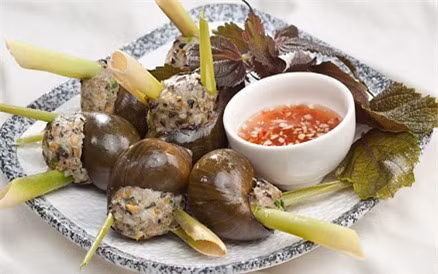 Đặt lớp vỏ sả vào giữa miệng ốc rồi nhồi phần thịt ốc vào giữa. Lần lượt làm như vậy cho đến hết phần nguyên liệu. Xếp ốc vào xửng rồi hấp chín. Trong lúc đợi ốc chín bạn pha mắm chua ngọt để chấm kèm. Ảnh: phunutoday.com.