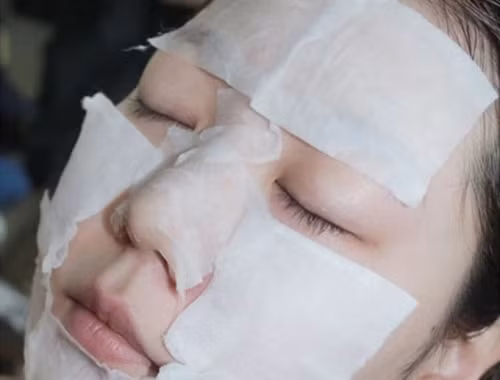 Dùng miếng bông tẩy trang hoặc bông gòn thấm hỗn hợp nước giấm rau mùi thoa đều lên khu vực da điều trị. Vừa thoa vừa kết hợp massage da để các dưỡng chất nhanh thấm vào da hơn trong 20 phút rồi dùng nước rửa lại mặt cho sạch. Ảnh: nghean24h.vn.