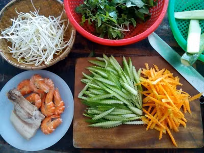 1. Nộm dưa chuột, cà rốt và tôm, thịt. Nguyên liệu: Dưa leo, cà rốt, tôm, thịt ba chỉ, nước cốt chanh, nước mắm, đường, muối, tỏi, ớt, gừng, rau thơm, đậu phộng rang. Đem cà rốt và dưa chuột ướp với 1/2 muỗng cà phê muối và để trong khoảng 15 phút. Lưu ý, để riêng hai loại và khi vớt ra nhớ vắt ráo nước. Ảnh: tapchigaidinh.com.vn.