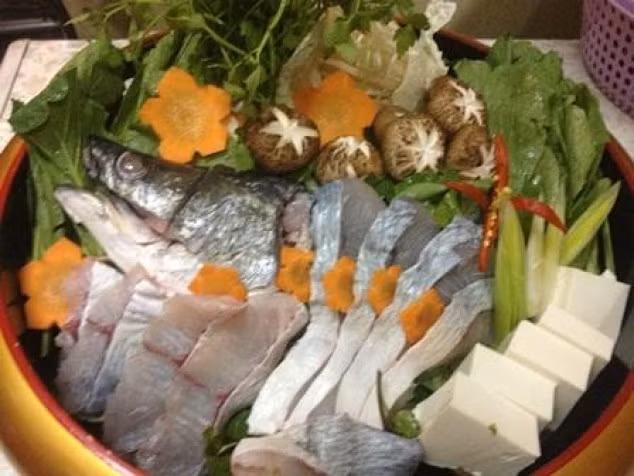 Cà chua, khế rửa sạch. Phi thơm hành khô với chút dầu ăn, cho cà chua vào xào sau đó cho khế vào xào cùng. Mẻ hòa với ít nước lọc lấy nước cốt. Các loại rau rửa sạch, ngâm nước muối loãng sau đó vớt ra để ráo. Khi nước dùng xương đã được, vớt xương ống để riêng, cho cà chua, khế, mẻ và đầu cá vược vào đun sôi nhỏ lửa. Ảnh: Sotaynauan.vn.