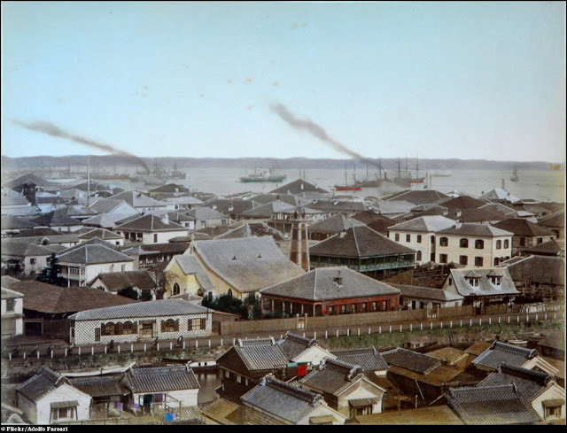 Những ngôi nhà cổ ở Nhật Bản nằm san sát nhau. Phía xa là tàu thuyền hoạt động tấp nập ra vào bến cảng.