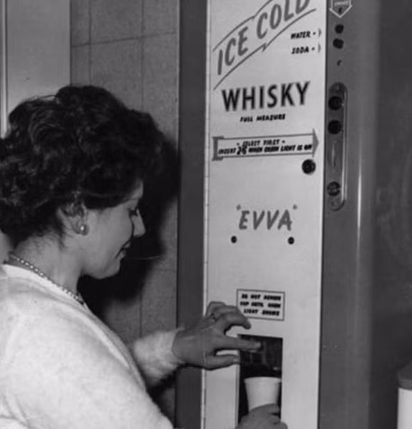 Máy bán rượu tự động được một một phụ nữ sử dụng vào năm 1960.