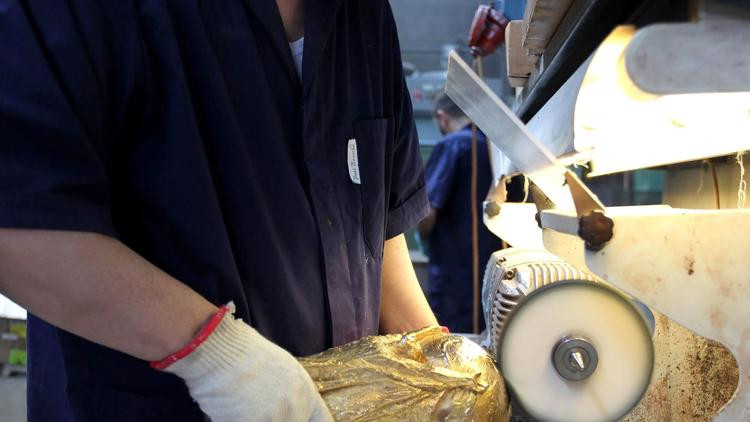 Một nhân viên tại GDE Bertoni của Paderno Dugnano, Milan, Italy đang đánh bóng chiếc cúp vàng của FIFA World Cup 2018. Công ty sản xuất nằm ở phía bắc nước Ý, nơi có trách nhiệm lau chùi và xử lý cup từ năm 1971.