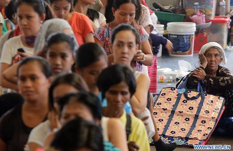 Người dân xếp hàng nhận đồ cứu trợ tại một trung tâm sơ tán tạm thời ở thủ đô Manila hôm 8/2. Ảnh: THX.