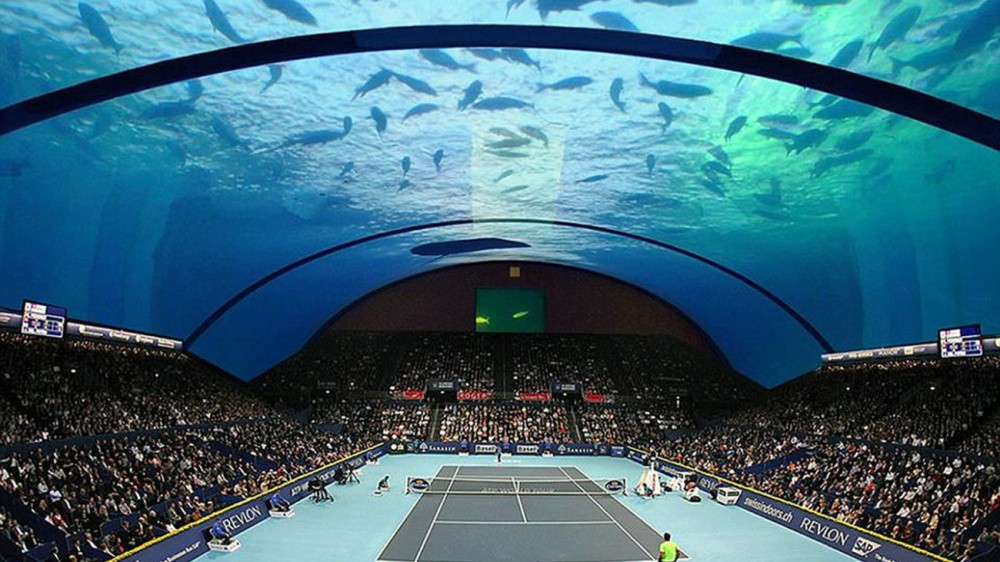 Công trình nhà thi đấu thể thao đa năng dưới đáy đại dương của Dubai, khán giả vừa có thể theo dõi trận đấu, vừa được thư giãn với đàn cá tung tăng phía trên mái vòm.