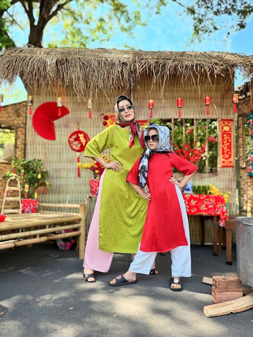 Trịnh Kim Chi cùng con gái thứ hai mặc áo dài tạo dáng trước tiểu cảnh đón Tết.