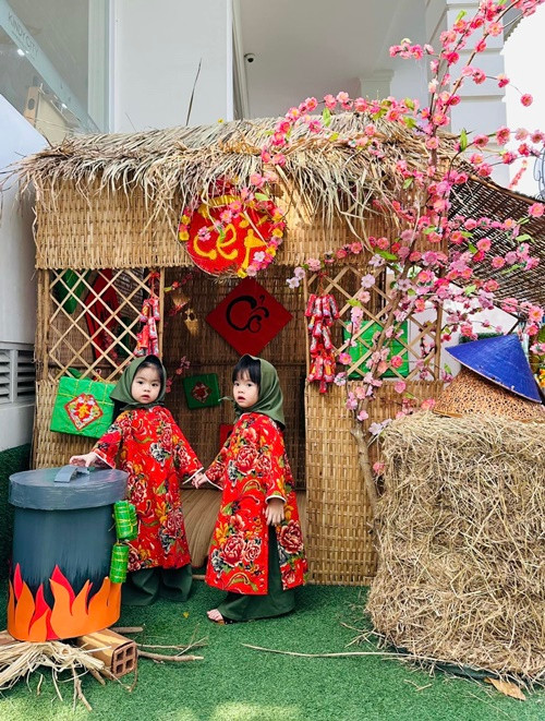 Hai bé Lê Quỳnh và Lê Quí diện áo dài họa tiết chăn con công.