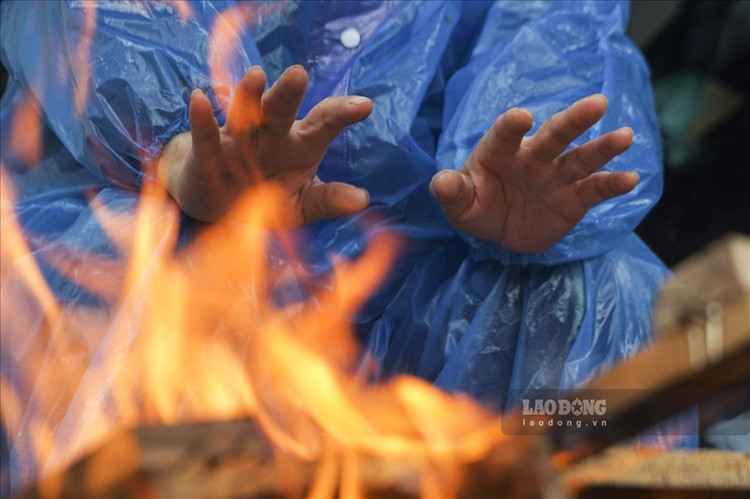 Trời rét kèm theo mưa nhỏ khiến cuộc sống của người dân bị ảnh hưởng. (Ảnh: Lao Động).