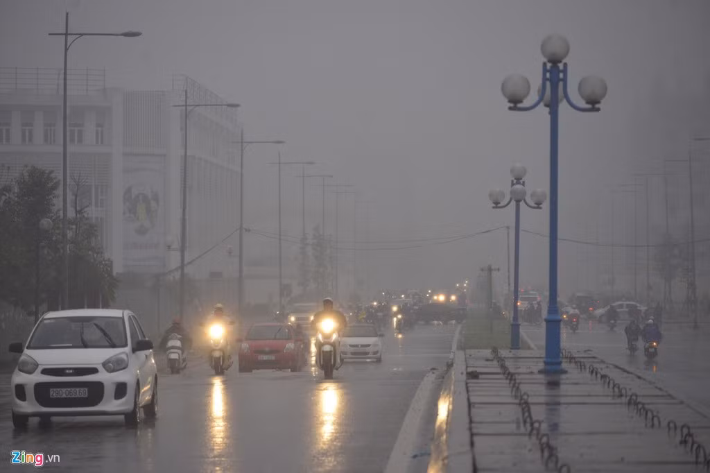 Khu vực làng Việt kiều châu Âu (quận Hà Đông) lúc 7h45. Do Hà Nội có mưa, trời hơi tối, nhiều người đi ôtô, xe máy phải bật đèn chiếu sáng.